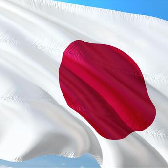 Japan flag against blue sky 
