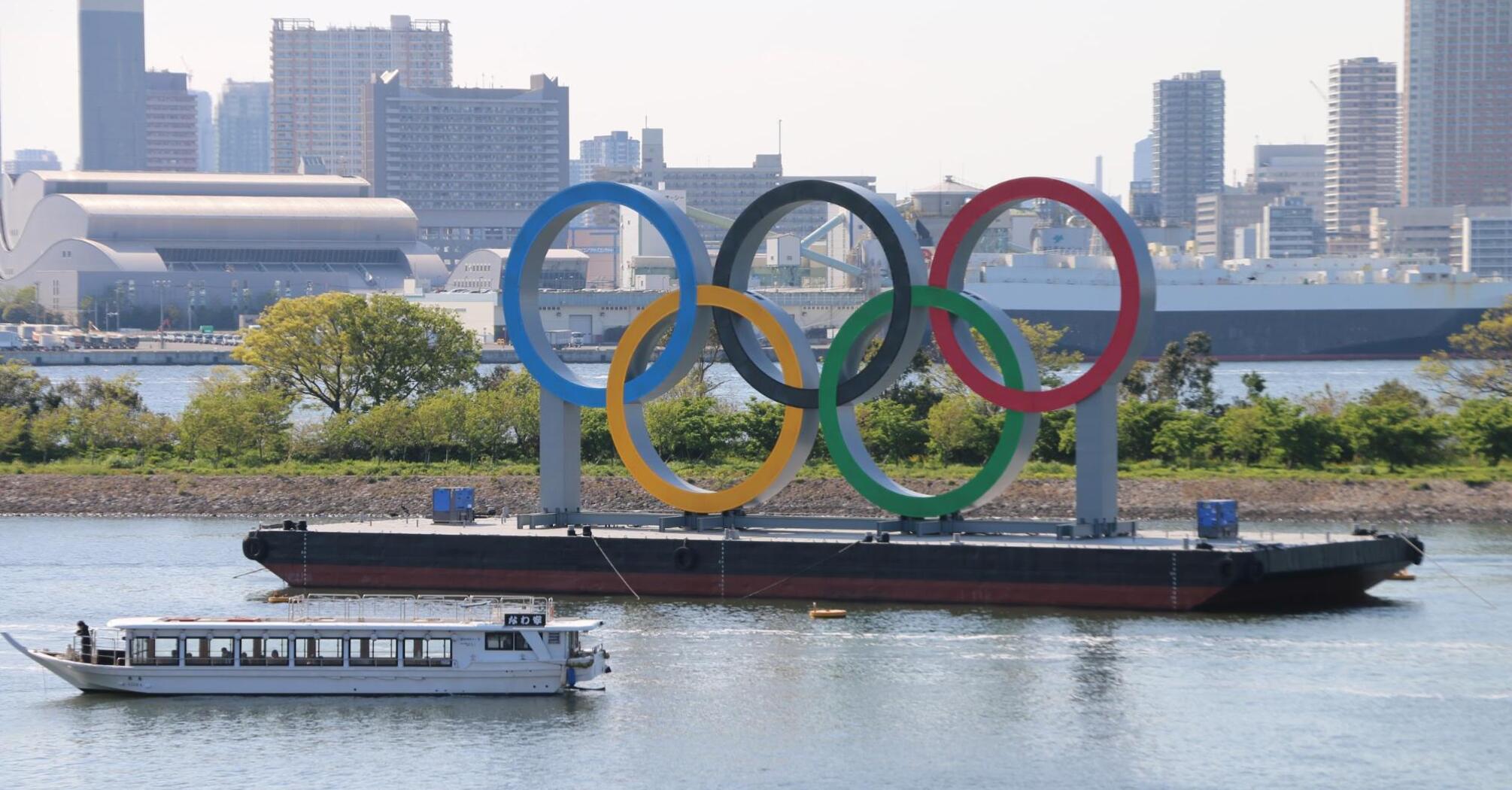 Olympic rings afloat near the city