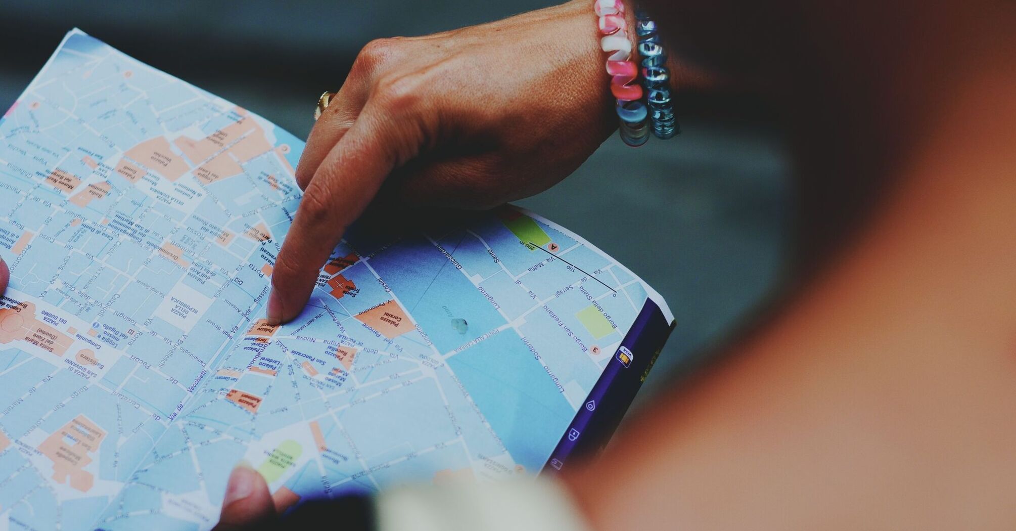 A person pointing at a location on a map