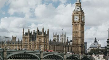 A view of the iconic Big Ben and the Houses of Parliament in London, with Westminster Bridge in the foreground