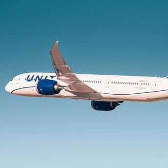 White and blue passenger plane in flight
