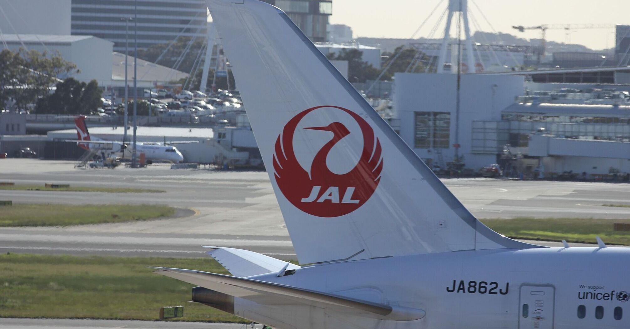 Japan Airlines (JAL) aircraft tail with logo at the airport