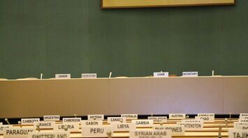 Conference room with country name placards and designated seats