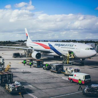 A large jetliner sitting on top of an airport tarmac