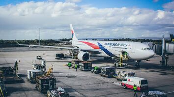 A large jetliner sitting on top of an airport tarmac
