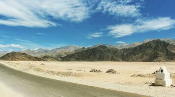 Gray concrete road with range mountain view