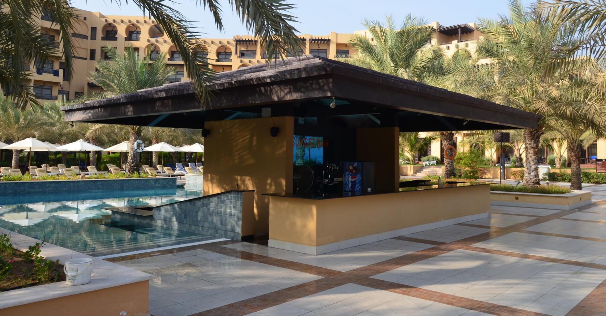 Bar near the pool with sunbeds