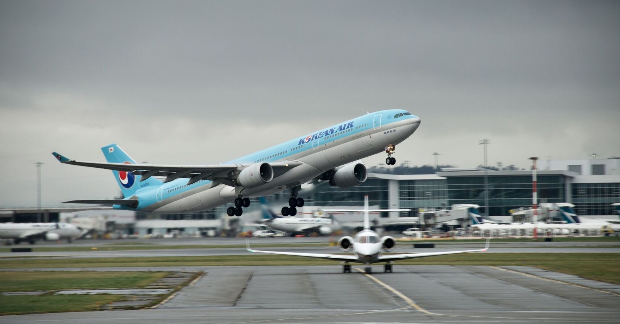 Korean Air aircraft taking off from the runway on a cloudy day