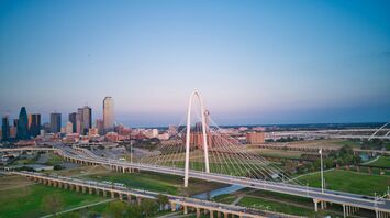 An aerial view of a city with a bridge in the foreground