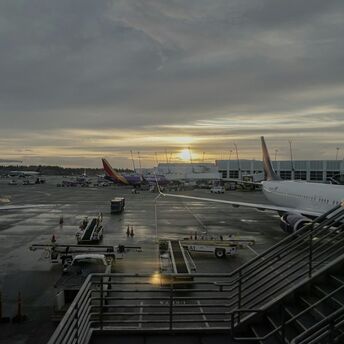 Evening view of the tarmac at John F. Kennedy International Airport, New York, with planes parked near terminals