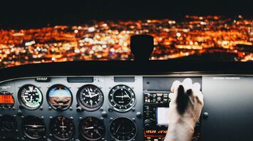 Сockpit with view of city lights at night