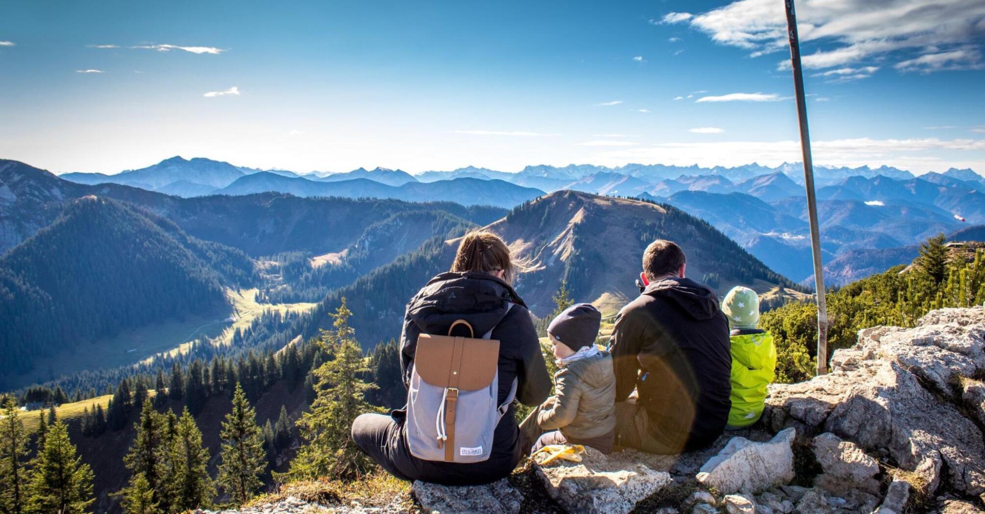 A married couple with two children admiring the landscape