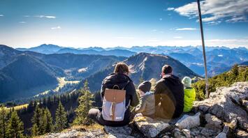 A married couple with two children admiring the landscape