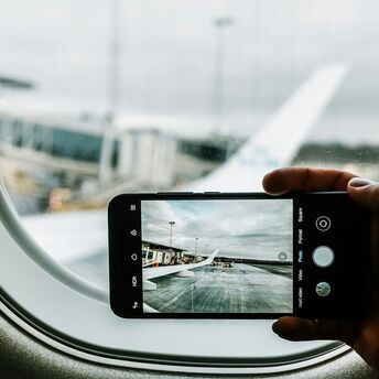 Photo of an airplane wing taken through an airplane window at Billund Airport