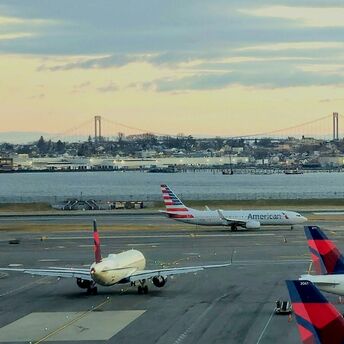 A bunch of airplanes that are on a runway