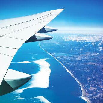 The photo shows an airplane wing viewed from the window during flight