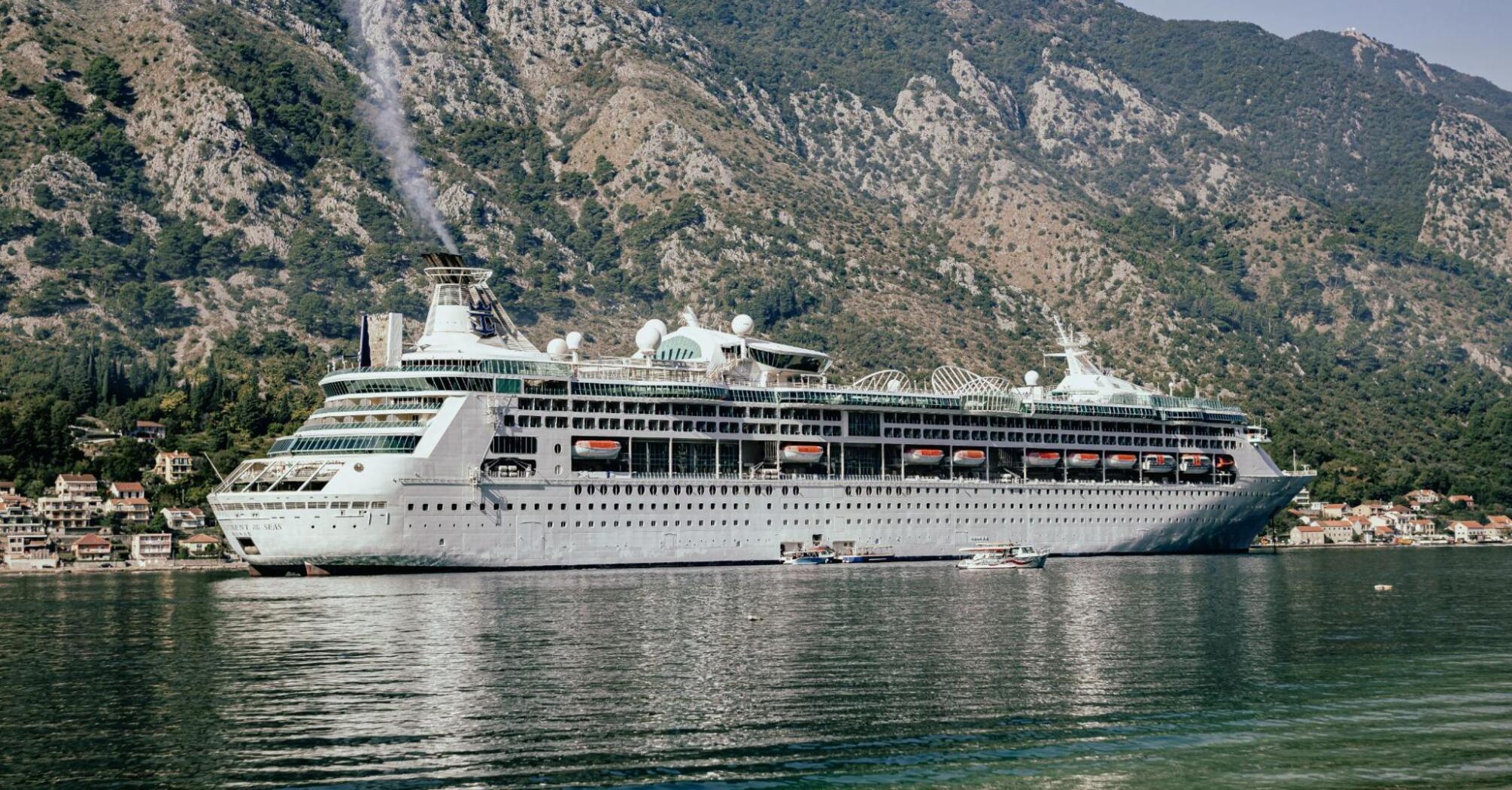 Beautiful cruise ship surrounded by mountains