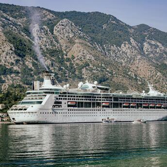 Beautiful cruise ship surrounded by mountains