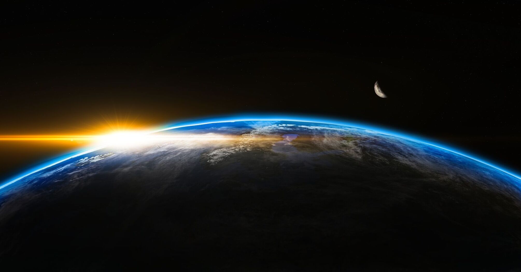 Sunrise over Earth from space, with a bright orange glow on the horizon and a dark night sky in the background