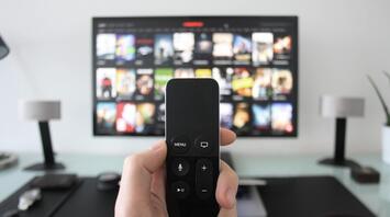 Black TV remote control with TV