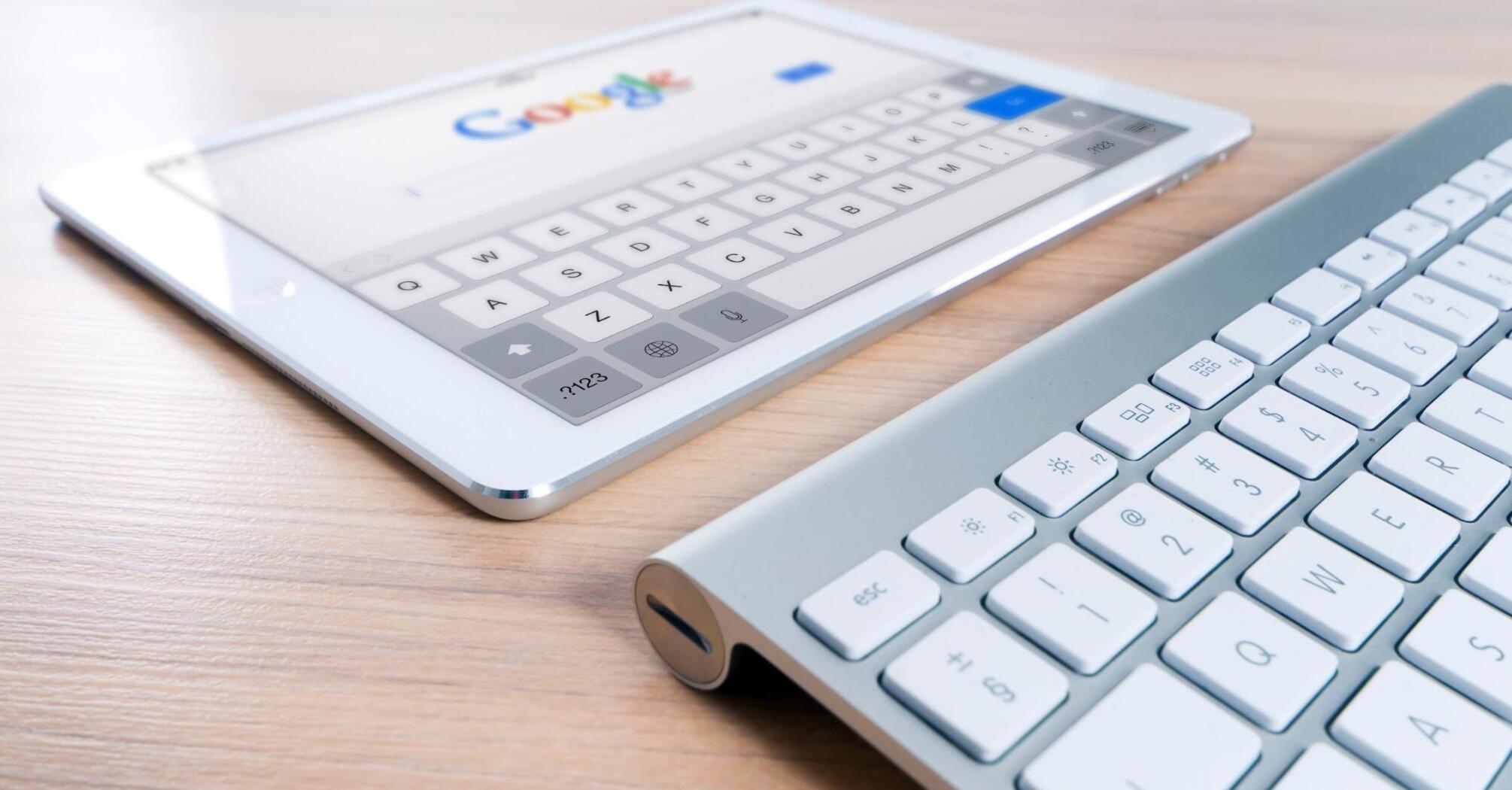 White tablet with a keyboard with google search