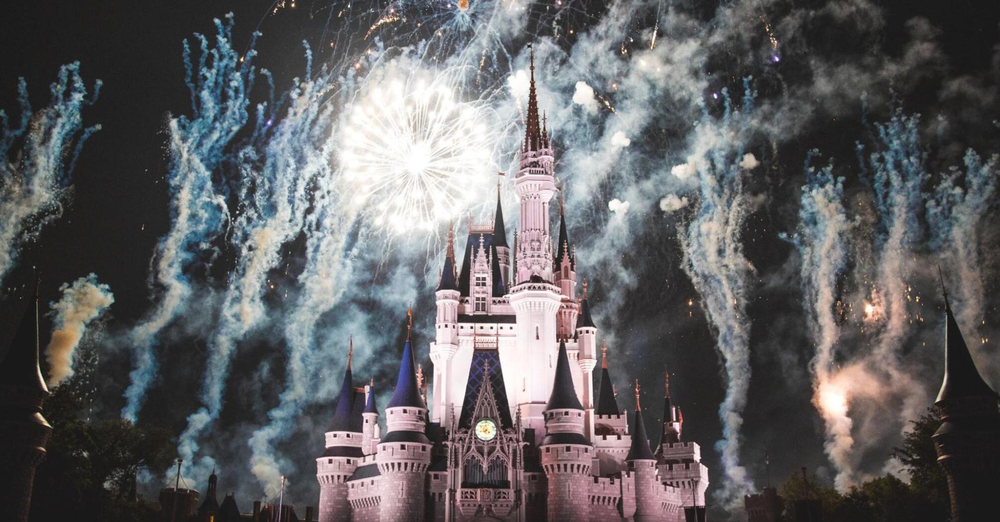 Disney castle surrounded by fireworks