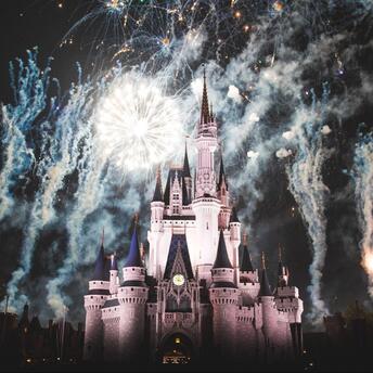 Disney castle surrounded by fireworks