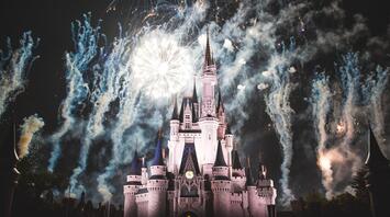 Disney castle surrounded by fireworks