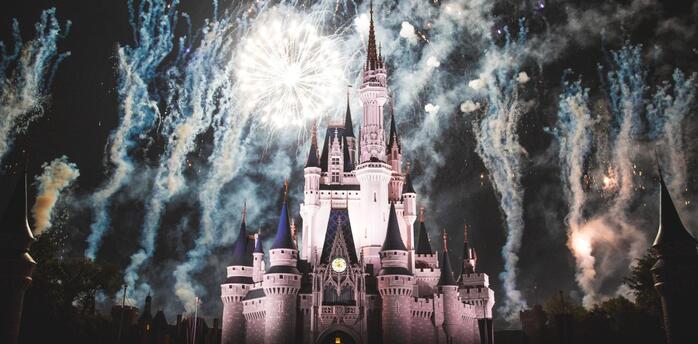 Disney castle surrounded by fireworks