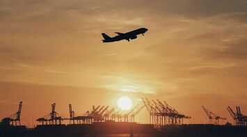 An airplane taking off during sunset