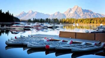 Boats and yachts moored off the coast against the backdrop of mountains