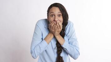 Woman covered her mouth with her hands