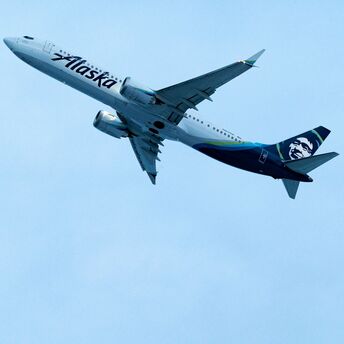 Alaska Airlines plane flying in the sky