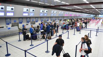 People standing in the queque inside airport