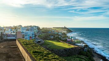 View of a colorful coastal San Juan with a vibrant landscape along a seashore, under a clear blue sky