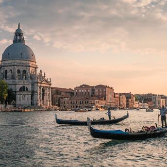 People cross the Venice canal on gondolas