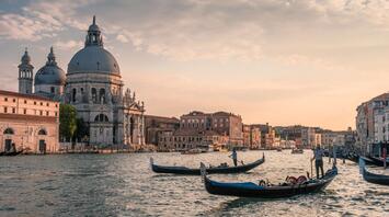 People cross the Venice canal on gondolas