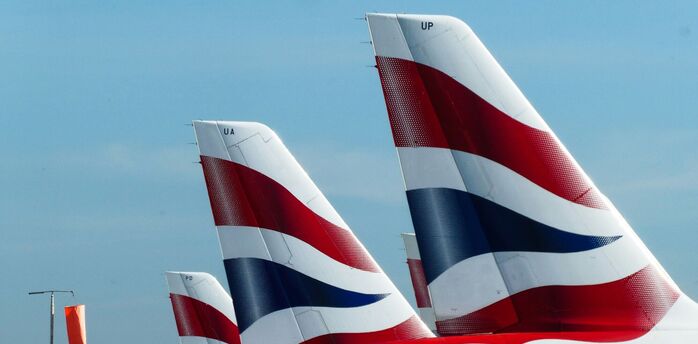 The tails of British Airways aircraft displaying the airline's red, white, and blue logo