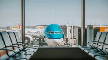 Airplane parked near passenger pathway