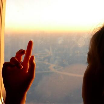Little girl looking out the airplane window