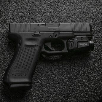 A black handgun on a dark textured surface