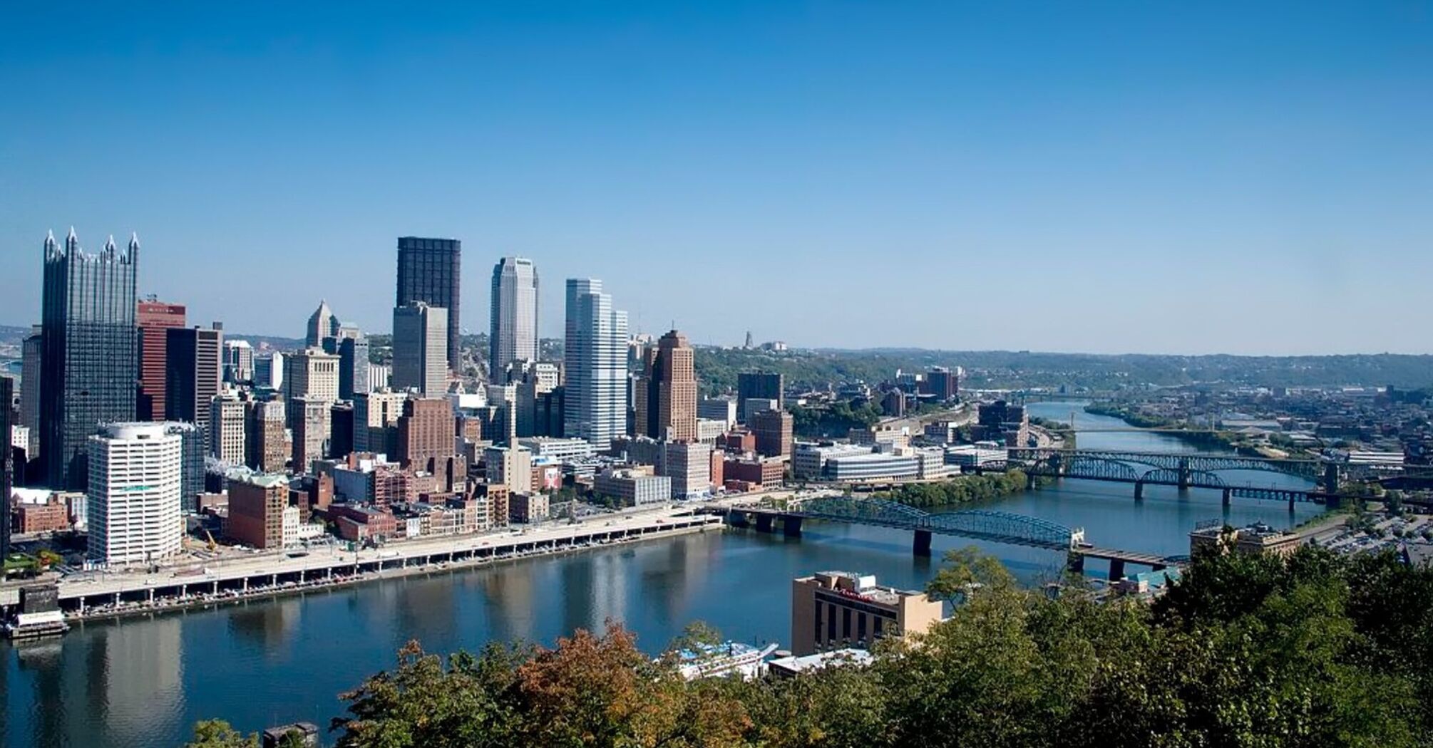 Pittsburgh city skyline with river and bridges in the foreground