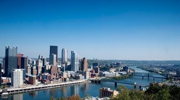 Pittsburgh city skyline with river and bridges in the foreground