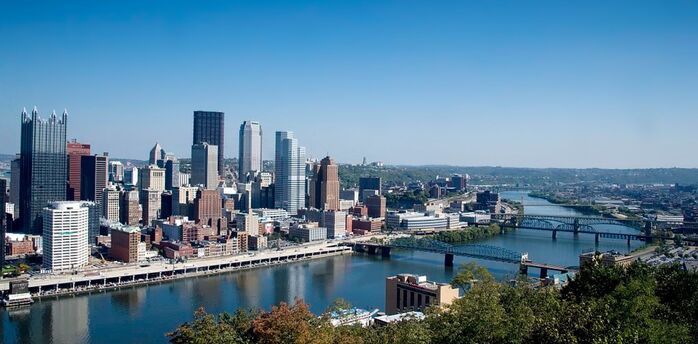 Pittsburgh city skyline with river and bridges in the foreground
