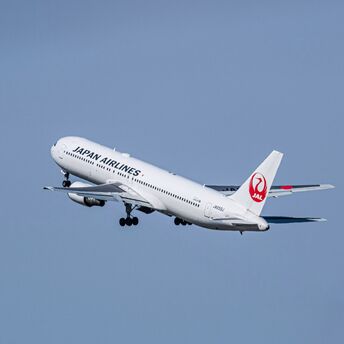 A large jetliner flying through a blue sky