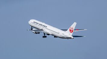 A large jetliner flying through a blue sky