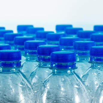 Transparent bottles with blue caps