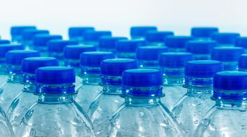 Transparent bottles with blue caps