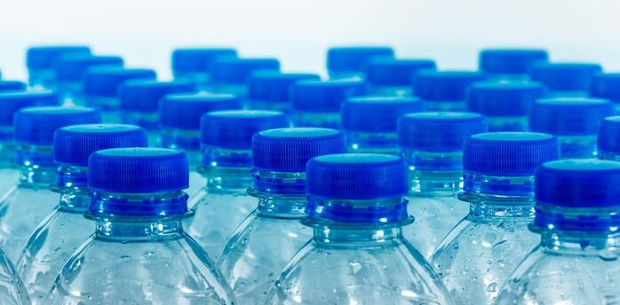 Transparent bottles with blue caps