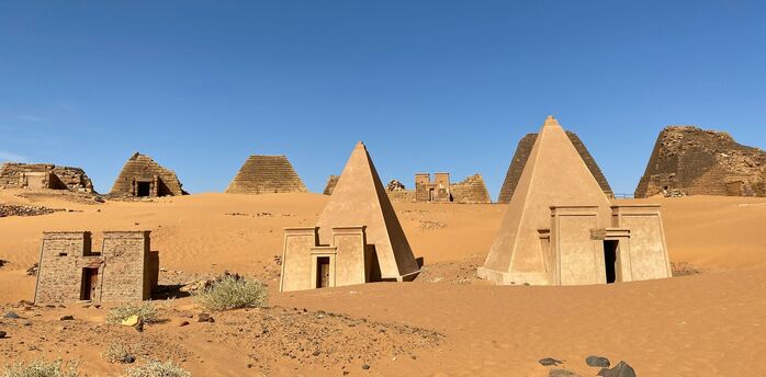 A group of pyramids sitting in the middle of a desert